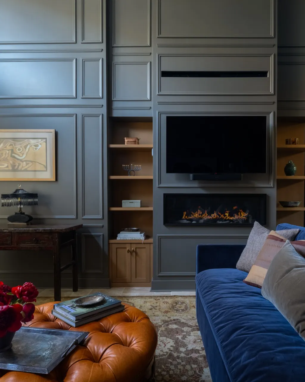 NU Curations interior design project featuring den paneled media wall fireplace