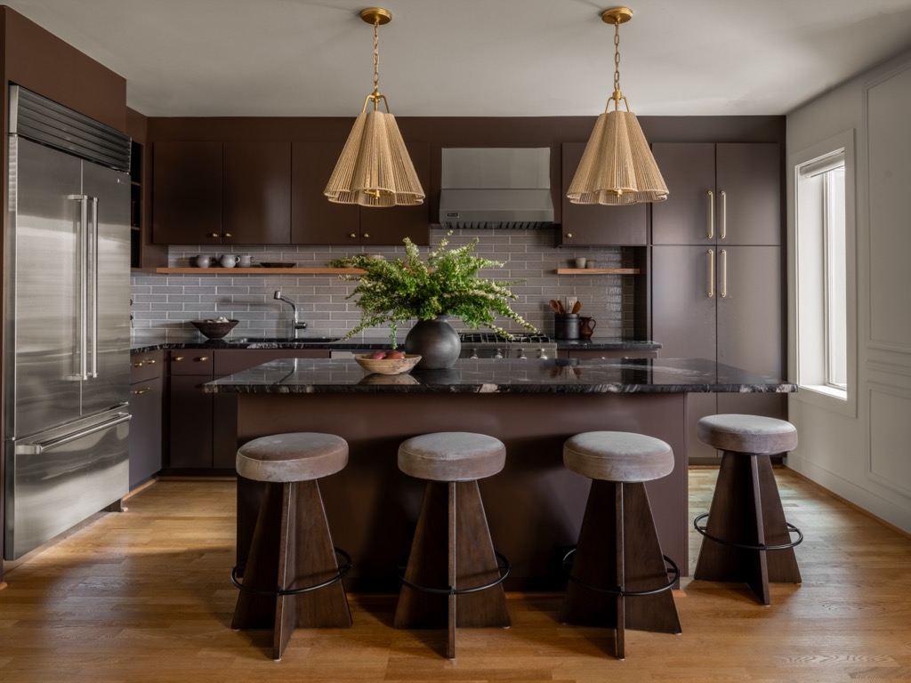 NU Curations editorial homepage hero featuring kitchen brown cabinets marble island