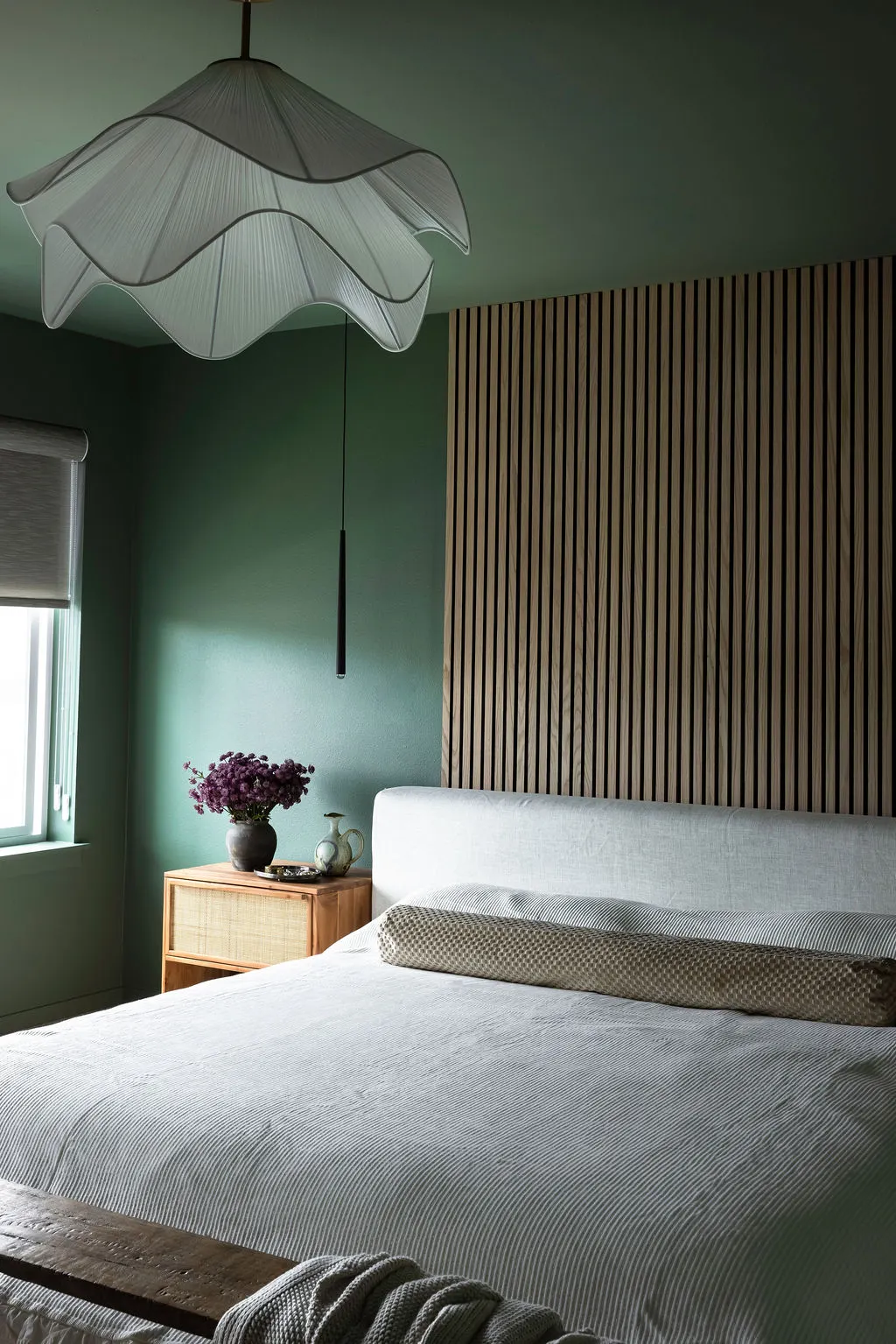 NU Curations project featuring green bedroom layered lighting